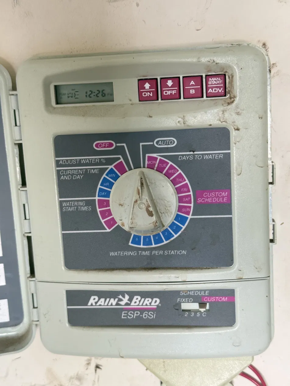 The faceplate of the Rain Bird ESP-6Si controller the sidecar is designed for, with its analog scheduling dial